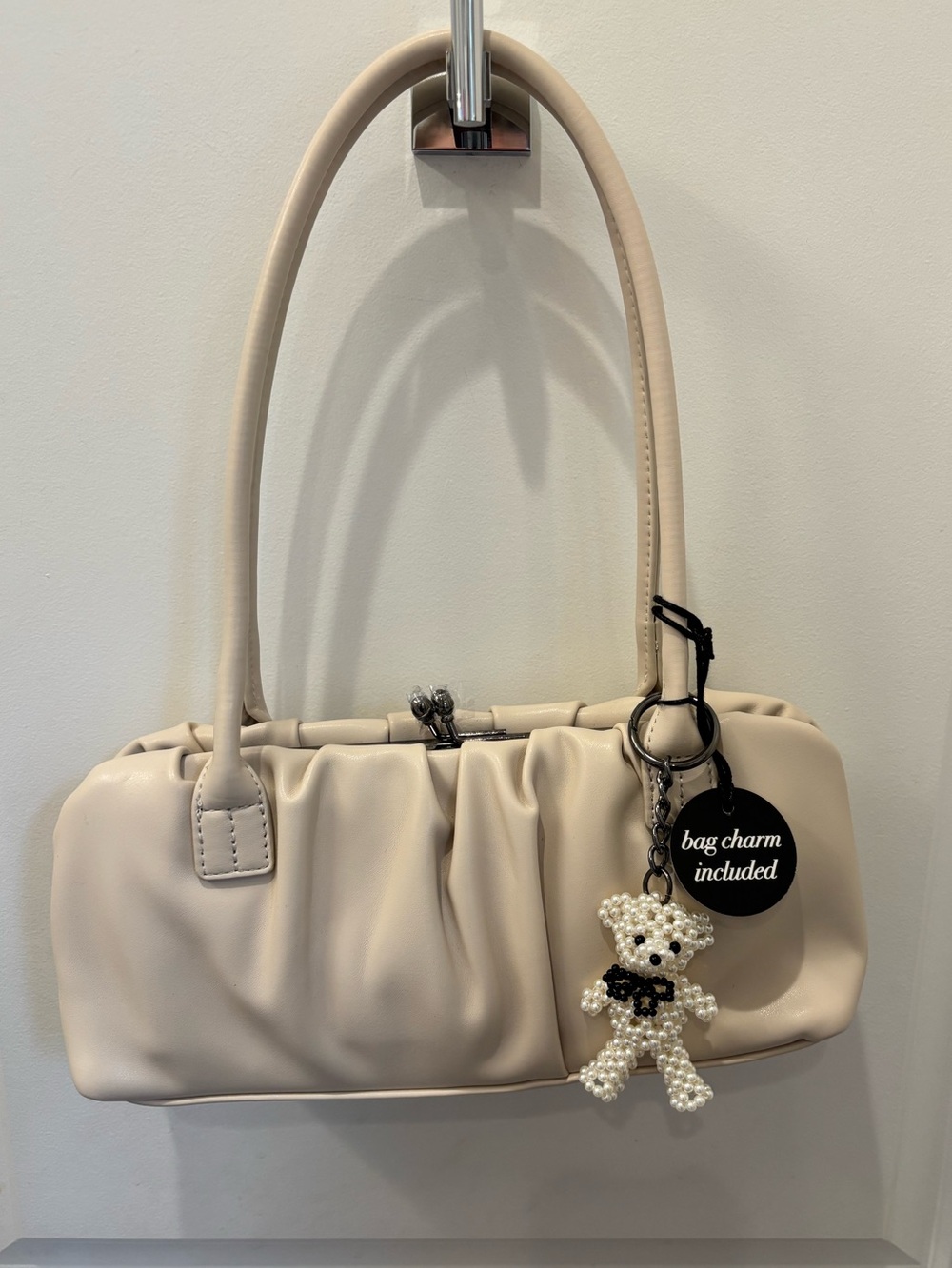 NWT BCBG Creamy beige baguette bag with pearly bear bag charm